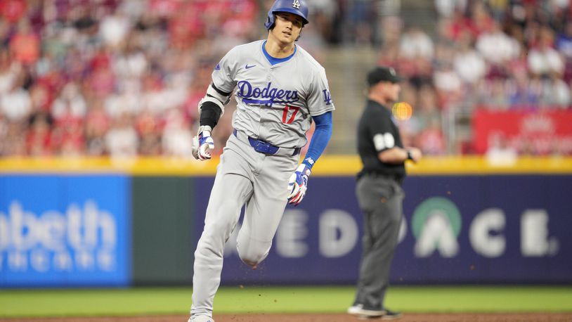 Los Angeles Dodgers' Shohei Ohtani rounds the bases after hitting a triple during the sixth inning of a baseball game against the Cincinnati Reds, Saturday, May 25, 2024, in Cincinnati. (AP Photo/Jeff Dean)