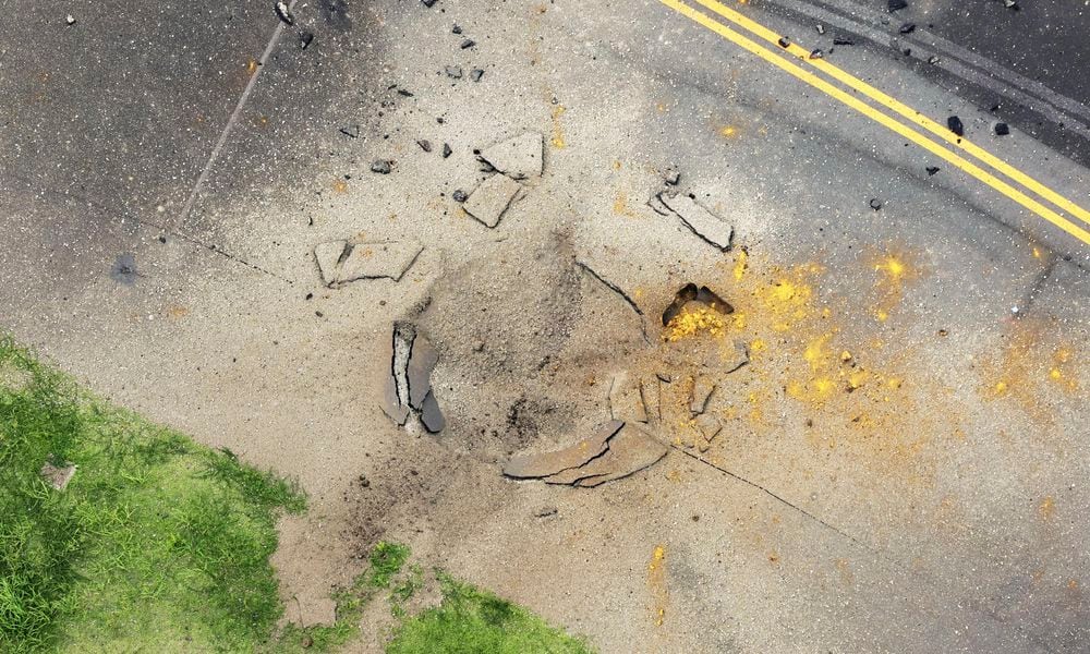 This photo taken from a Kyodo News helicopter shows part of a damaged taxiway at Miyazaki Airport in southwestern Japan, Wednesday, Oct. 2, 2024, after an explosion was reported. (Kyodo News via AP)