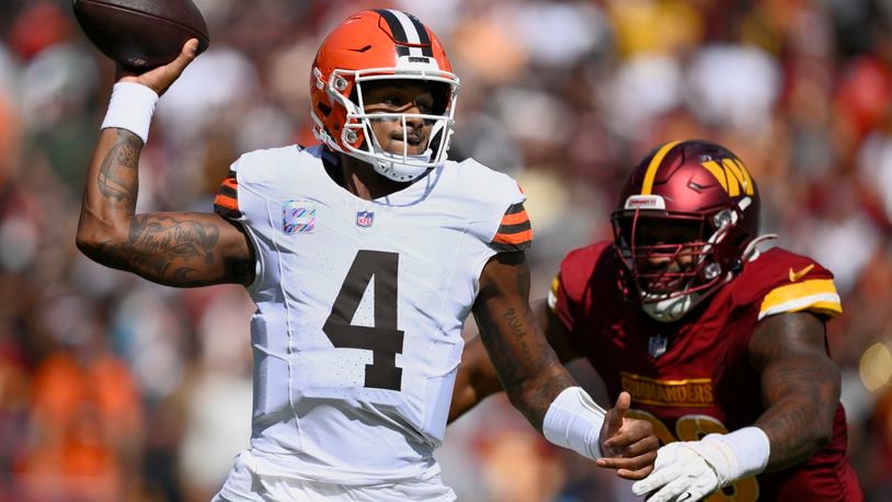 Cleveland Browns quarterback Deshaun Watson (4) looks to pass under pressure from Washington Commanders defensive tackle Phidarian Mathis (98) during the first half of an NFL football game in Landover, Md., Sunday, Oct. 6, 2024. (AP Photo/Nick Wass)