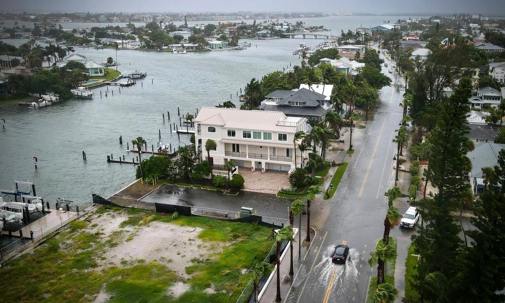 A driver negotiates a flooded street as Tropical Storm Debby passes just to the west of the Tampa Bay, Fla., region, Sunday, Aug. 4, 2024. (Max Chesnes/Tampa Bay Times via AP)