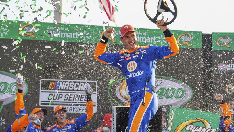 Joey Logano, center, celebrates in Victory Lane after winning a NASCAR Cup Series auto race Sunday, Sept. 8, 2024, in Hampton, Ga. (AP Photo/Jason Allen)