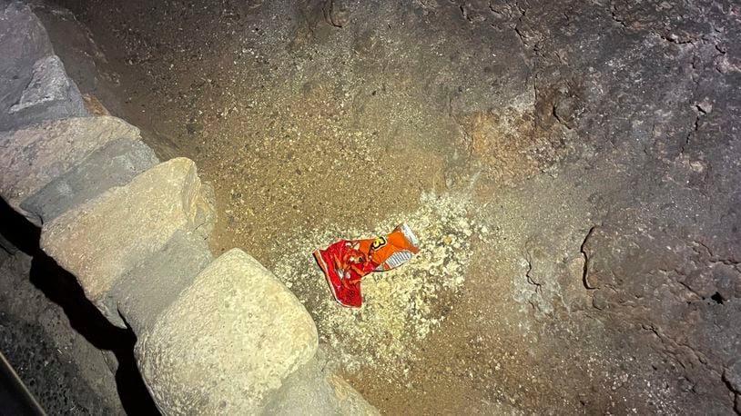 This undated photo provided by Carlsbad Caverns National Park shows a bag of Cheetos that was dropped off trail by a visitor in the Big Room at the national park near Carlsbad, N.M.(Carlsbad Caverns National Park via AP)