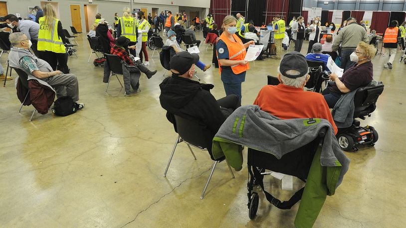 Hundreds of people arrived at the Dayton Convention Center Wednesday morning, Jan. 20, 2021, for the COVID-19 vaccination. MARSHALL GORBY\STAFF