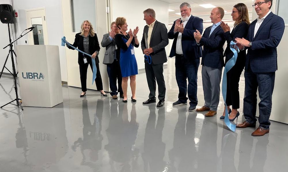 The ribbon is cut: LIbra Industries and Dayton leaders celebrate the opening of a new $1.8 million clean room to support semiconductor fabrication work in Dayton Thursday. THOMAS GNAU/STAFF