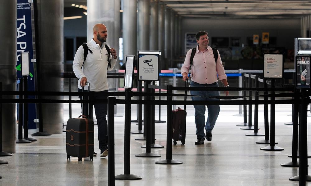 Travelers walk through Dayton International Airport Thursday, June 27, 2024. The airport will be busy for Independence Day week as travel nationwide is expected to be 5% greater than in 2023 and 8% greater than 2019. MARSHALL GORBY/STAFF