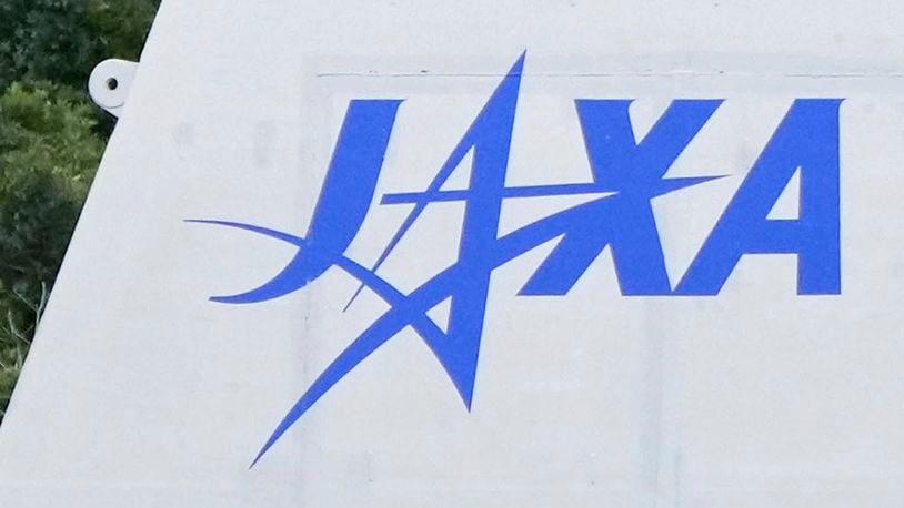 FILE - The logo of the Japan Aerospace Exploration Agency, or JAXA, is seen at its Tanegashima Space Center in Minamitanecho, Kagoshima prefecture, Feb. 16, 2024. Japan’s space agency said Friday, June 28, 2024 its planned launch this weekend of a satellite on its new flagship H3 rocket will be postponed until Monday due to expected bad weather. (Kyodo News via AP, File)