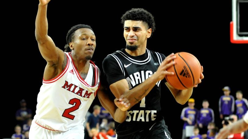 Wright State's Trey Calvin, 1, drives past Miami's Mekhi Lairy, 2, during the first half of a non-conference game at Millett Hall on Thursday, Dec. 22. DAVID A. MOODIE/CONTRIBUTING PHOTOGRAPHER