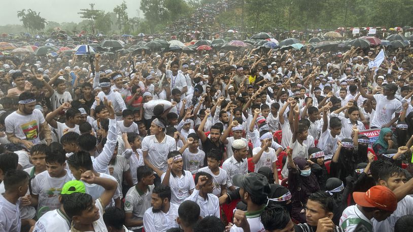 Hundreds of Rohingyas gather in the rain to demand safe return to Myanmar's Rakhine state as they mark the seventh anniversary of their mass exodus from Myanmar at their refugee camp at Kutupalong in Cox's Bazar district, Bangladesh, Sunday, Aug. 25, 2024. (AP Photo/ Shafiqur Rahman)