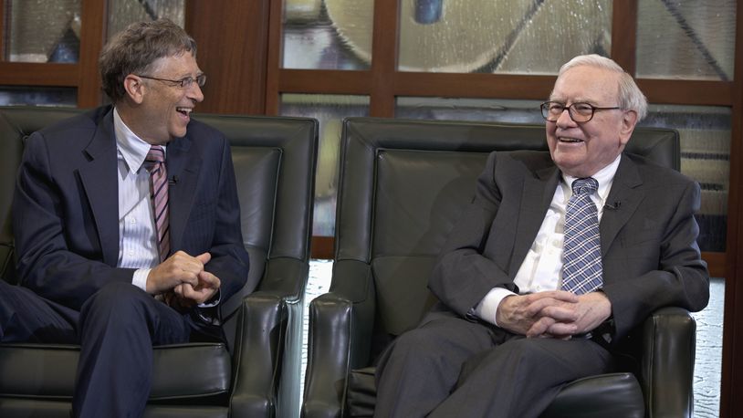 FILE - Warren Buffett, chairman and CEO of Berkshire Hathaway, right, looks at Microsoft founder and Berkshire board member Bill Gates during an interview with Liz Claman of the Fox Business Network in Omaha, Neb., May 7, 2012. Buffett announced another $5.3 billion in charitable gifts Friday, June 28, 2024, but in a major shift of his longtime giving plan, he says he plans to cut off donations to the Bill & Melinda Gates Foundation after his death and let his three children decide how to distribute the rest of his $128 billion fortune. (AP Photo/Nati Harnik, File)