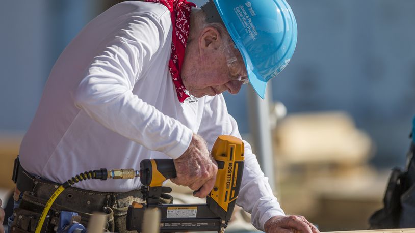 FILE- In this Aug. 27, 2018 file photo, former President Jimmy Carter works with other volunteers on site during the first day of the weeklong Jimmy & Rosalynn Carter Work Project, their 35th work project with Habitat for Humanity, in Mishawaka, Ind. Carter turns 95 on Tuesday, Oct. 1, 2019. (Robert Franklin/South Bend Tribune via AP, File)