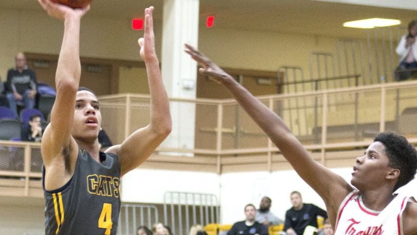 Springfield’s David Sanford shoots over Troy’s Tre’Vone Archie during the Wildcats’ 67-43 victory in a second-round sectional game Thursday night at Vandalia Butler. Sanford made three 3-pointers and scored 13 points. Jeff Gilbert/CONTRIBUTED