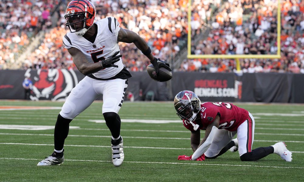 Cincinnati Bengals wide receiver Tee Higgins (5) gets past Tampa Bay Buccaneers defensive back Josh Hayes (32) as Higgins scores a touchdown in the first half of an NFL preseason football game Saturday, Aug. 10, 2024, in Cincinnati. (AP Photo/Jeff Dean)