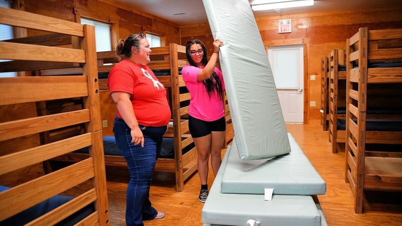 Ashley Durst (left) and Lydia Durst prepare a cabin at Indian Hills 4-H Camp in Miami County, which is undergoing a rebirth after years of under-use. CONTRIBUTED PHOTO