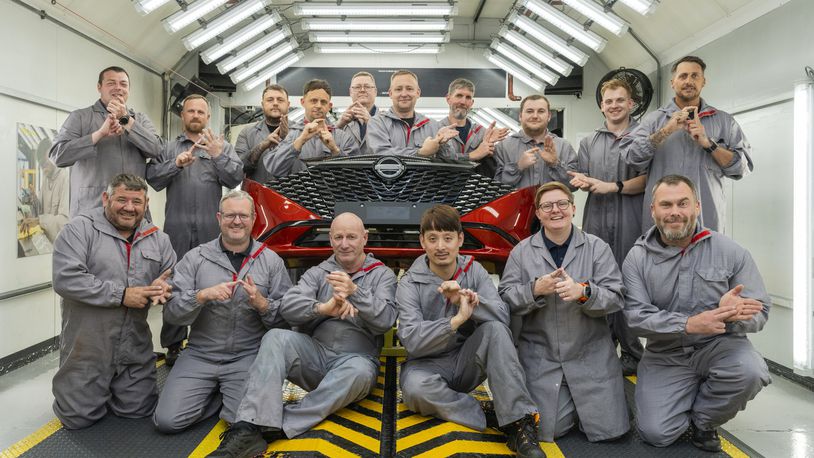 In this photo provided by Nissan on Thursday, Sept. 5, 2024, workers of Nissan's plant’s Paint Shop including John Johnson, foreground right and Michael Connolly, foreground, second left, pose for a photo at the plant, in Sunderland, England. (Matt Walker/Nissan via AP)