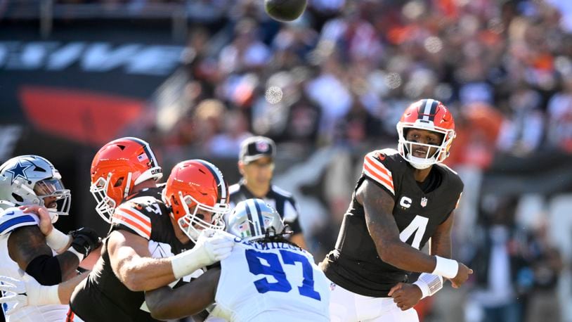 Cleveland Browns quarterback Deshaun Watson (4) throws a pass under pressure from Dallas Cowboys defensive tackle Osa Odighizuwa (97) in the first half of an NFL football game in Cleveland, Sunday, Sept. 8, 2024. (AP Photo/David Richard)