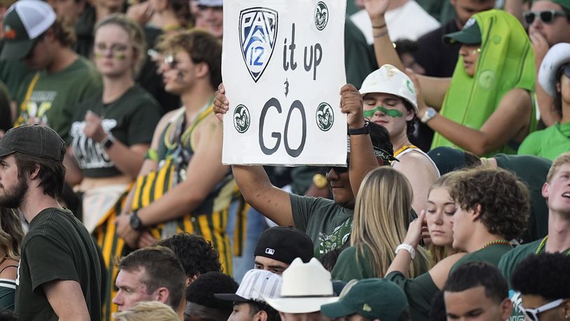 A Colorado State fan holds up a sign to mark the school's move to the Pac-12 Conference from the Mountain West during the first half of an NCAA college football game against Colorado, Saturday, Sept. 14, 2024, in Fort Collins, Colo. (AP Photo/David Zalubowski)