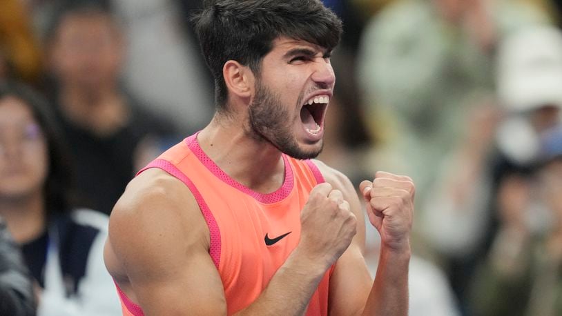 Carlos Alcaraz of Spain reacts after winning against Jannik Sinner of Italy during their men's singles finals match of the China Open tennis tournament, at the National Tennis Center in Beijing, Wednesday, Oct. 2, 2024. (AP Photo/Achmad Ibrahim)