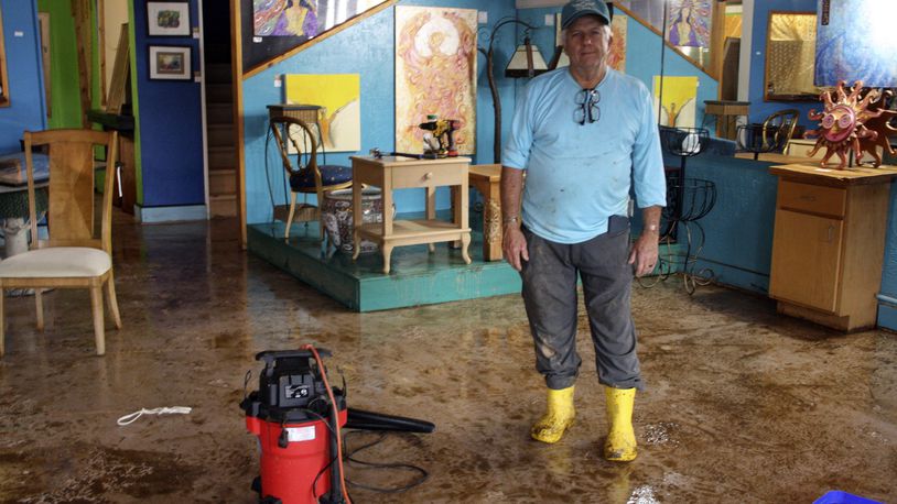 Freddie Pell stands in his art gallery in downtown Boone, N.C., that was flooded when Tropical Storm Helene passed over western North Carolina, Monday, Sept. 30, 2024. (AP Photo/Makiya Seminera)