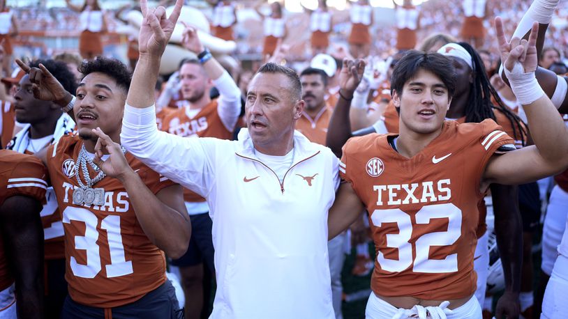 Texas head coach Steve Sarkisian, center, joins players for the school song following their win over Mississippi State in an NCAA college football game in Austin, Texas, Saturday, Sept. 28, 2024. (AP Photo/Eric Gay)