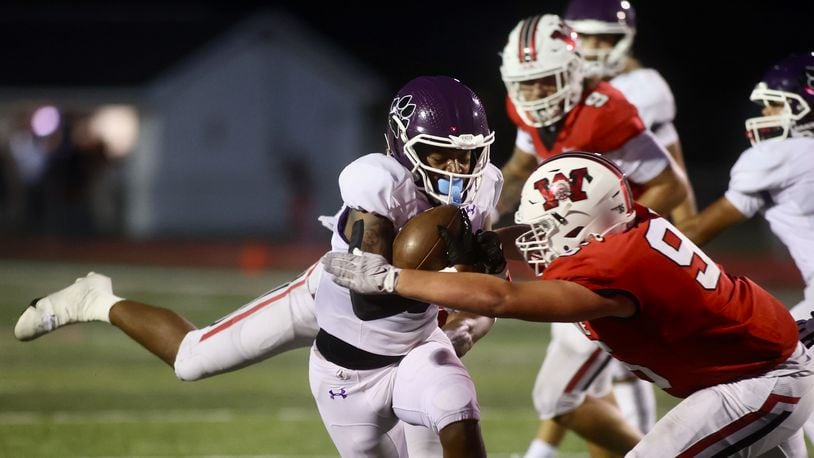 Pickerington Central's Kaejuan Alexander is tackled by Wayne's JD Bryant on Friday, Aug. 30, 2024, at Heidkamp Stadium in Huber Heights. David Jablonski/Staff