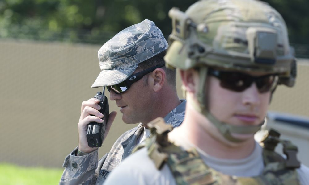 Staff Sgt. Michael Kent, 788th Civil Engineer Squadron, explosive ordinance disposal technician, radios back to the EOD control desk information from Senior Airman Tyler Squibb, 788th CES, EOD technician, after he performed a recon on an unexploded ordinance during an exercise at Wright-Patterson Air Force Base in August 2016. (U.S. Air Force photo / Wesley Farnsworth)