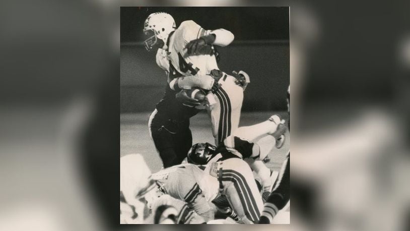 Roth High School running back Keith Byars (44) is stopped by a Meadowdale defender on Oct. 10. 1981 at Welcome Stadium. Byars went on to stardom at Ohio State and a 13-year NFL career. Photo courtesy of DDN Collection at Wright State University Special Collections & Archives