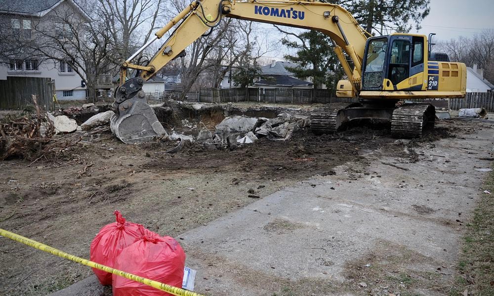 Crews excavating a torn down house in the 1300 block of Huffman Avenue in Dayton found a body in the basement, police said. MARSHALL GORBY \STAFF