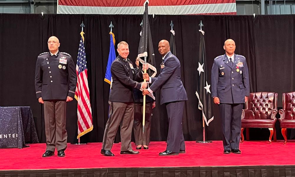 Space Force Col Marcus Starks, to the immediate right of the military guidon or banner, accepted command of the National Space Intelligence Center at Wright-Patterson Air Force Base Friday. Handing off the guidon, on the banner's immediate left, was Maj. Gen. Gregory Gagnon. THOMAS GNAU/STAFF