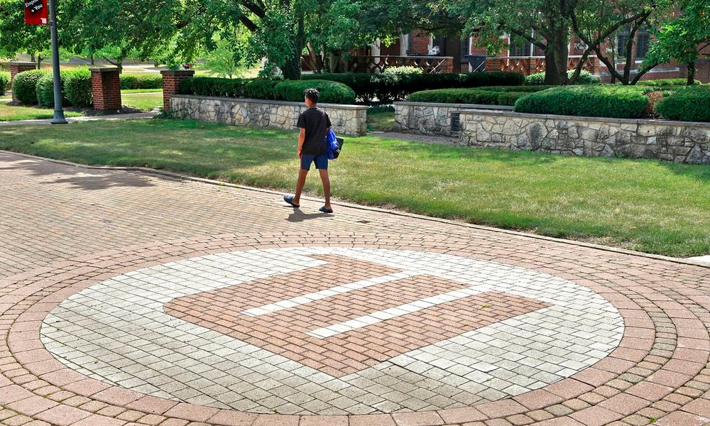 A man walks across the campus of Wittenberg University Thursday, August 1, 2024. BILL LACKEY/STAFF