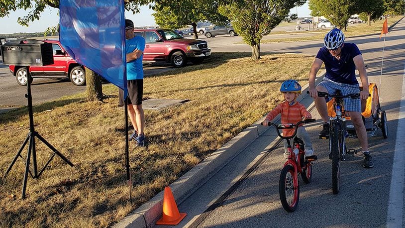Maj. Will Jones of the Air Force Materiel Command Law Office with his son James, who is 4, get ready to cycle at the starting line of the Blue Streak Time Trial. The Oct. 13 was the final ride of the 2019 season. (Contributed photo/Chuck Smith)