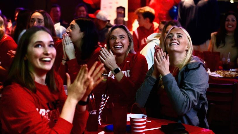 The Dayton volleyball team reacts to seeing its name on the NCAA tournament selection show during a watch party at Milano's on Brown Street on Sunday, Nov. 26, 2023, in Dayton. David Jablonski/Staff