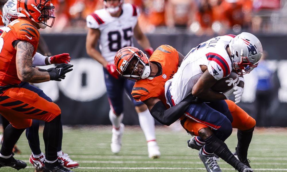 Bengals cornerback Dax Hill tackles Patriots wide receiver Ja'Lynn Polk during their 16-10 loss to New England Patriots Sunday, Sept. 8, 2024 at Paycor Stadium in Cincinnati. NICK GRAHAM/STAFF