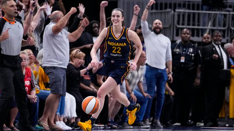 Indiana Fever guard Caitlin Clark (22) smiles after gabbing her tenth rebound in the closing seconds of a games against the Los Angeles Sparks in the second half of a WNBA basketball game in Indianapolis, Wednesday, Sept. 4, 2024. The rebound gave Clark a triple-double for the game. (AP Photo/Michael Conroy)