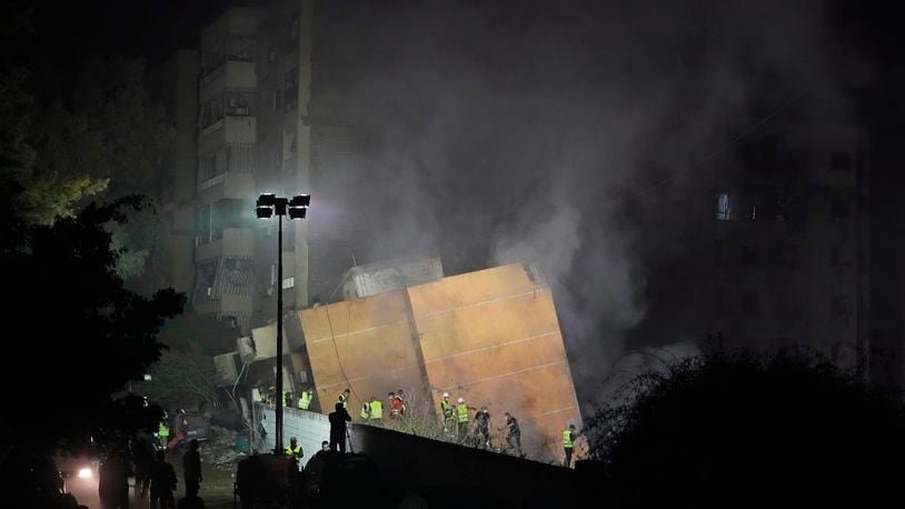 Rescuers arrive at the site of an Israeli airstrike in Beirut's southern suburbs, Friday, Sept. 27, 2024. (AP Photo/Hassan Ammar)