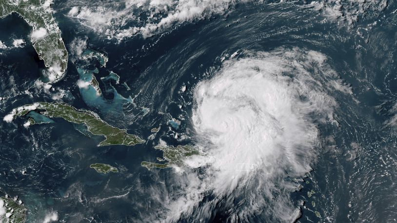 This GOES-16 GeoColor satellite image taken at 4 p.m EDT and provided by National Oceanic and Atmospheric Administration (NOAA) shows Hurricane Ernesto northwest of San Juan, Puerto Rico and moving over open waters, Wednesday, Aug. 1214 2024. (NOAA via AP)