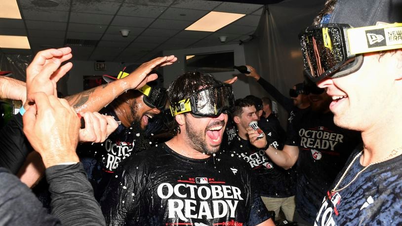 The Cleveland Guardians celebrate after their 10-inning win over the Minnesota Twins in a baseball game to clinch a playoff berth Thursday, Sept. 19, 2024, in Cleveland. (AP Photo/Nick Cammett)