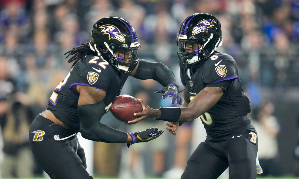 Baltimore Ravens running back Derrick Henry, left, takes a handoff from quarterback Lamar Jackson while running for a long touchdown against the Buffalo Bills during the first half of an NFL football game, Sunday, Sept. 29, 2024, in Baltimore. (AP Photo/Stephanie Scarbrough)