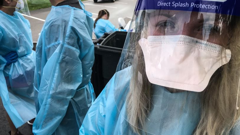 Jennifer Lowe, a member of the Ohio National Guard out of Mansfield Ohio, performs COVID-19 test at a Pop-Up COVID-19 Testing spot at Kettering Fields in Dayton Tuesday August 18, 2020.