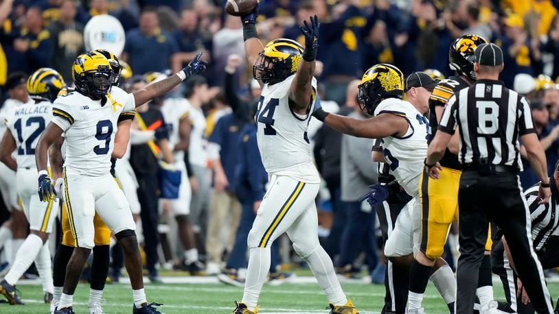 Michigan defensive lineman Kris Jenkins (94) celebrates after recovering a fumble during the first half of the Big Ten championship NCAA college football game against Iowa, Saturday, Dec. 2, 2023, in Indianapolis. (AP Photo/AJ Mast)
