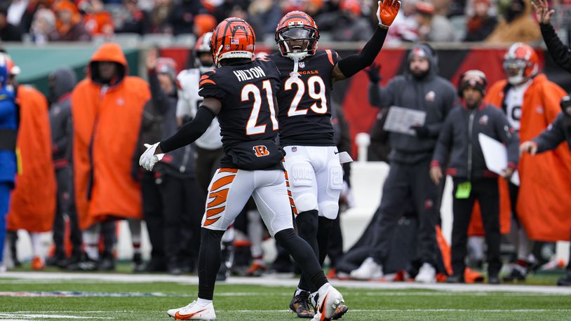 Cincinnati Bengals cornerback Mike Hilton (21) and Cam Taylor-Britt (29) celebrate a tackle for a loss against the Cleveland Browns during the first half of an NFL football game in Cincinnati, Sunday, Jan. 7, 2024. (AP Photo/Jeff Dean)