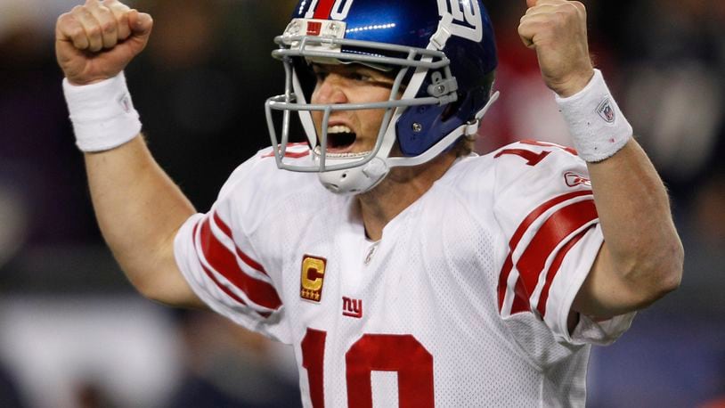 FILE - New York Giants quarterback Eli Manning celebrates his touchdown pass to tight end Jake Ballard in the last minute of an NFL football game against the New England Patriots in Foxborough, Mass., Sunday, Nov. 6, 2011. (AP Photo/Charles Krupa, File)