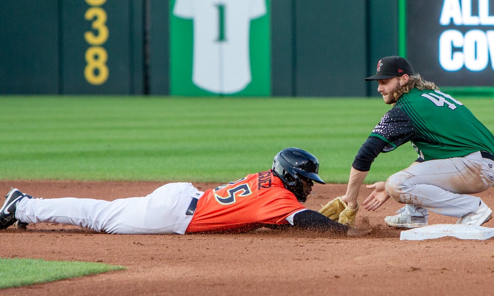 Dayton's Hector Rodriguez dives safely back into second base on a pick-off attempt as Great Lakes shortstop Noah Miller applies the tag Friday night at Day Air Ballpark. Jeff Gilbert/CONTRIBUTED