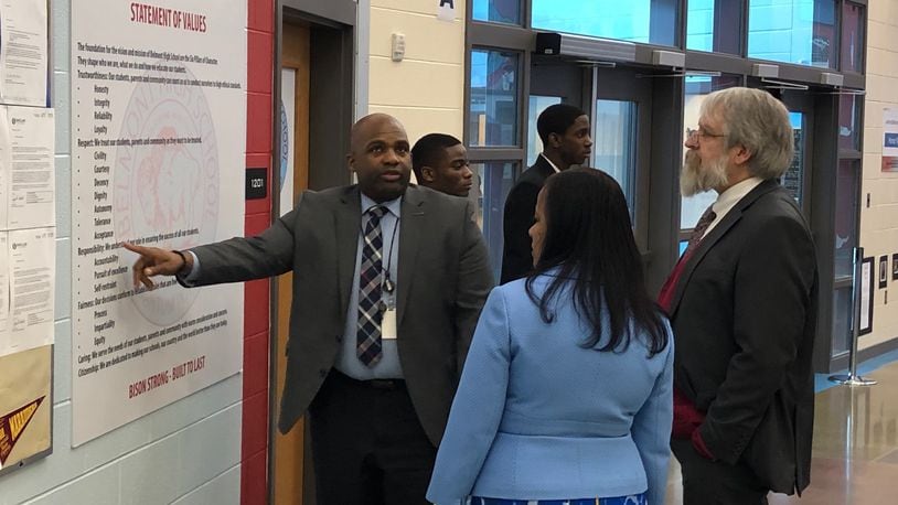 Belmont High School Principal Donetrus Hill shows some his school’s values to state Superintendent Paolo DeMaria and Dayton Public Schools Treasurer Hiwot Abraha, as two Belmont JROTC students wait to help. DeMaria toured several Dayton schools on Tuesday, Feb. 26, 2019. JEREMY P. KELLEY / STAFF