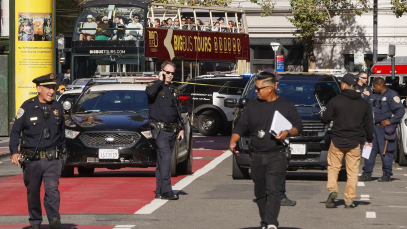 Police officers secure the area and investigate the scene of a shooting at Union Square in San Francisco, Saturday, Aug. 31, 2024. (Santiago Mejia/San Francisco Chronicle via AP)