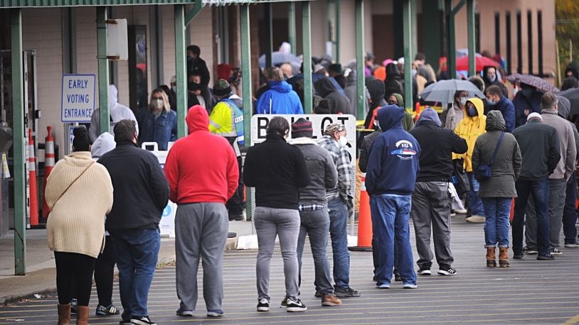 The rain and the cold weather on Friday, Oct. 30, 2020, did not stop voters in Greene County from lining up to vote early in Xenia. MARSHALL GORBY\STAFF