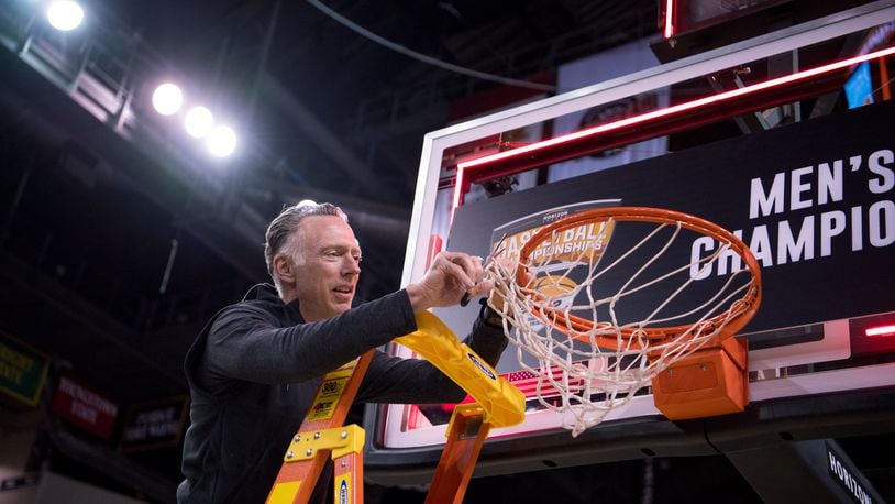 Wright State Athletic Director Bob Grant snips a piece of the net after the Raiders' men's basketball team defeated Northern Kentucky in the Horizon League Championship game on March 8, 2022. Joe Craven/Wright State Athletics