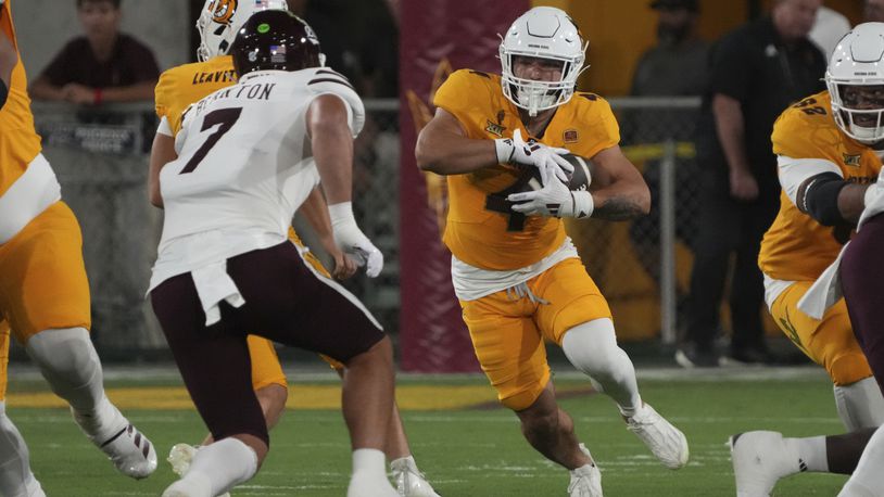 Arizona State running back Cam Skattebo (4) runs the ball against Mississippi State in the first half during an NCAA college football game, Saturday, Sept. 7, 2024, in Tempe, Ariz. (AP Photo/Rick Scuteri)