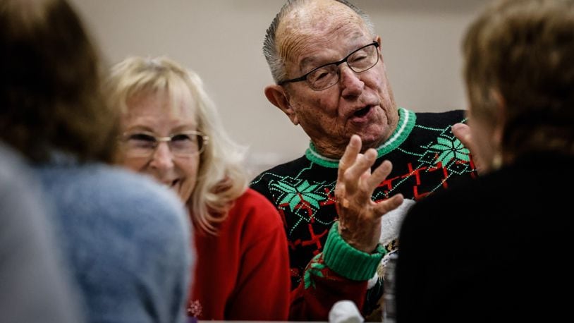 Joy and Paul Moyer enjoy conversation with other seniors at the Fairborn Senior Center Monday December 11, 2023. JIM NOELKER/STAFF