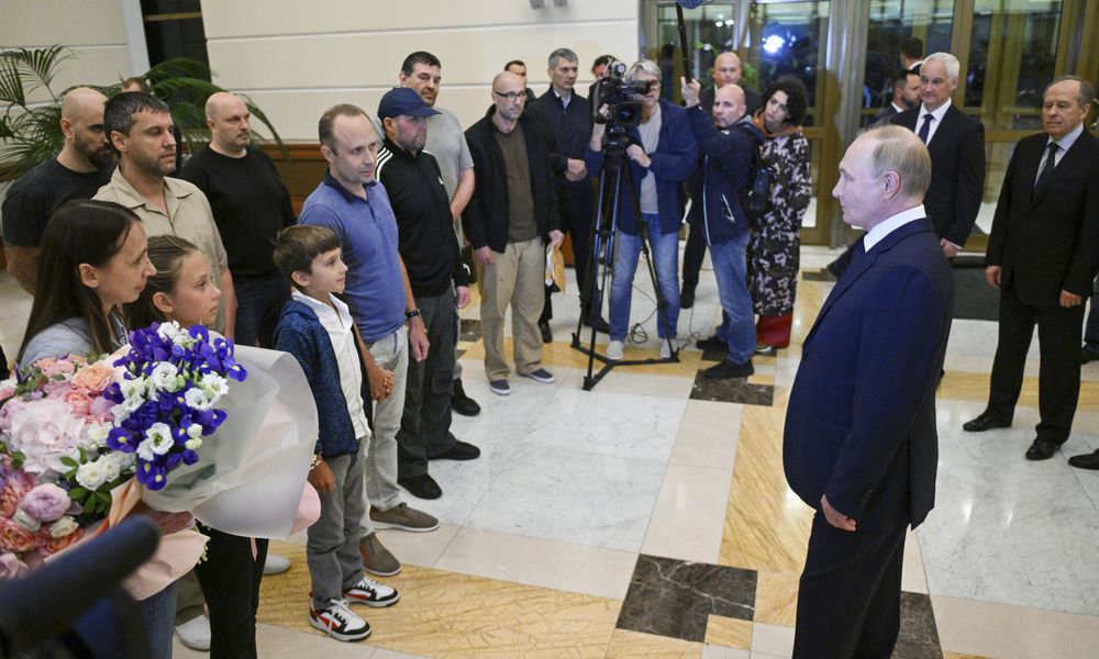 Russian President Vladimir Putin, right, speaks to released Russian prisoners upon their arrival at the Vnukovo government airport outside Moscow, Russia, on Thursday, Aug. 1, 2024. The United States and Russia have made their biggest prisoner swap in post-Soviet history. (Kirill Zykov, Sputnik, Kremlin Pool Photo via AP)