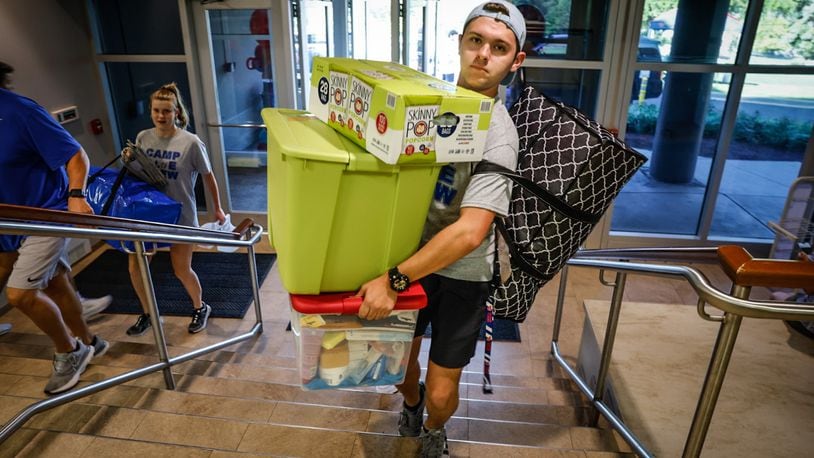 University of Dayton freshman Christos Bird, from Michigan, carries his stuff to his dorm room at Stuart Hall Friday August 18, 2023. UD enrollment remains high this year, with more than 11,000 undergraduates, graduate, doctoral and law students. JIM NOELKER/STAFF